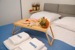 a tray of food on a table on a bed at Maya's Flats & Resorts 34 - Chmielna 73 in Gdańsk