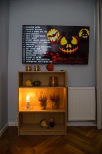 a room with a shelf with pumpkins on the wall at Maya's Flats & Resorts 34 - Chmielna 73 in Gdańsk