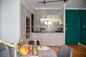 a kitchen with a table with a plate of food on it at Maya's Flats & Resorts 34 - Chmielna 73 in Gdańsk