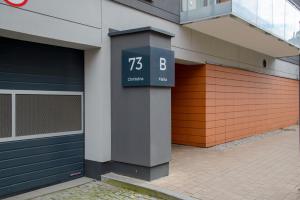 a clock on the side of a building at Maya's Flats & Resorts 34 - Chmielna 73 in Gdańsk