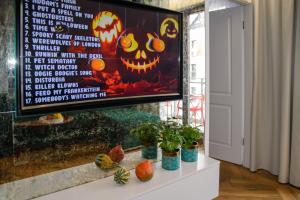a tv screen with a halloween pumpkin on it at Maya's Flats & Resorts 34 - Chmielna 73 in Gdańsk