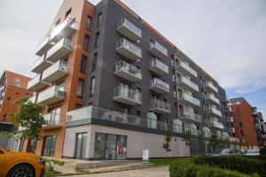 a building with balconies on the side of it at Maya's Flats & Resorts 34 - Chmielna 73 in Gdańsk
