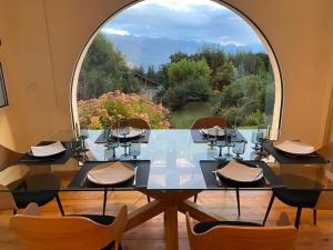 a dining room with a glass table and a large window at CHALET du GOLF CRANS MONTANA in Crans-Montana +40 photos