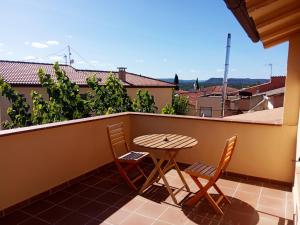 a table and chairs on a balcony with a view at El Cerezo in Torre del Compte