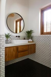 a bathroom with a sink and a mirror at KALAVA VILLA in Ahangama