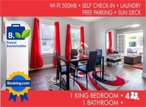 a red and white living room with a table and chairs at The Rubi Lounge - Spacious Brooklyn Centre Modern Escape Near Downtown With Parking, 300MB WiFi & Self Check-In in Cleveland