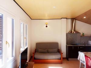 a living room with a couch in the corner of a room at El Cerezo in Torre del Compte