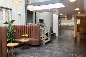 a lobby with a couch and a table and stairs at Hotel Reykjavík Centrum in Reykjavík