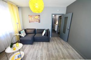 a living room with a couch and a table at Le cocon coloré - centre ville - 50m de la gare in Annecy