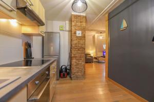 a kitchen with a sink and a counter top at Le Factory Duplex en vieille ville côté lac in Annecy