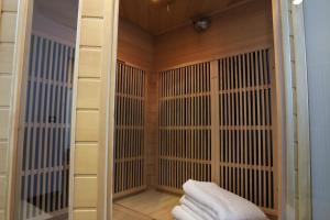a sauna with wooden walls and white towels at 2 bd apartment with sauna in the center of Annecy in Annecy +38 photos