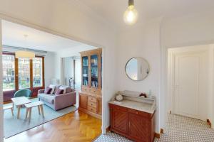 a living room with a couch and a table at Le Favre - 2 chambres au centre in Annecy +22 photos