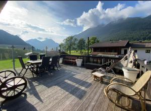 una terraza de madera con mesa y sillas. en Gästehaus Schmitt, en Lähn