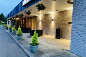 a row of potted plants sitting outside of a building at Britannia Hotel Newcastle Airport in Newcastle upon Tyne