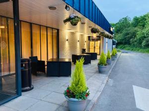 a row of tables and potted plants outside of a building at Britannia Hotel Newcastle Airport in Newcastle upon Tyne