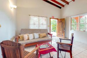 a living room with a couch and a table at Framadani Villas Gold Standard Certified in San Ignacio