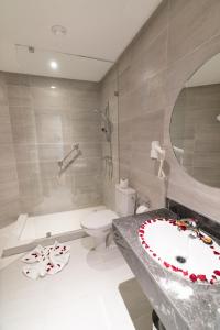 a bathroom with a sink and a shower and a toilet at Imperial Boutique Hotel Rabat in Rabat