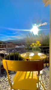 uma mesa amarela e cadeira numa varanda com o sol em SolGredos I em Arenas de San Pedro