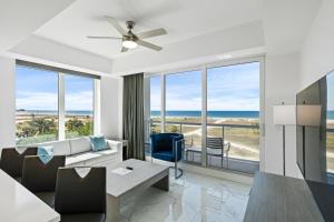a living room with a view of the ocean at Ocean Club Treasure Island Hotel in St Pete Beach
