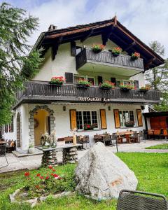 a building with a balcony with flowers on it at Chalet Alm in Zermatt