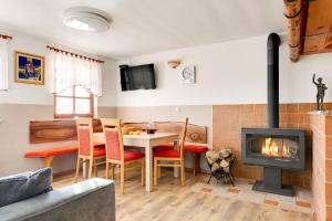 a living room with a table and a fireplace at Holiday Home Tramte In Vineyards - Happy Rentals in Škocjan