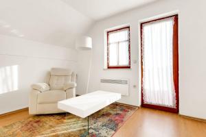 a white living room with a couch and a chair at Holiday Home Tramte In Vineyards - Happy Rentals in Škocjan