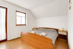 a bedroom with a bed with two teddy bears on it at Holiday Home Tramte In Vineyards - Happy Rentals in Škocjan