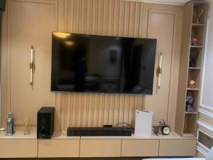 a flat screen tv sitting on top of a cabinet at Lovely 3 bedroom duplex in Ikeja GRA in Ikeja +5 photos