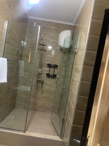 a shower with a glass door in a bathroom at Lovely 3 bedroom duplex in Ikeja GRA in Ikeja