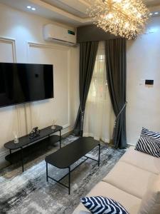 a living room with a couch and a table at Lovely 3 bedroom duplex in Ikeja GRA in Ikeja