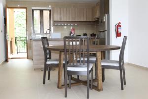 a kitchen with a wooden table and chairs at Belle Vue Lodge in Victoria