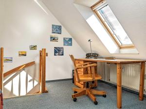 an attic office with a desk and a skylight at Hafenkieker in Kirchdorf