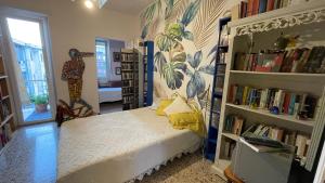 a bedroom with a bed in a room with bookshelves at BnB Tripoli in Turin
