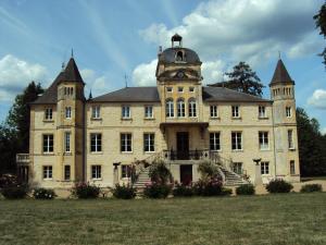 an old building with a clock tower on top of it at Chateau Du Four De Vaux in Varennes Vauzelles