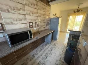 a living room with a television and a refrigerator at العين السخنة in Ain Sokhna