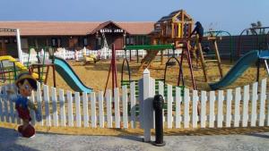 a white fence in front of a playground at العين السخنة in Ain Sokhna