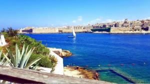 a view of a large body of water with a sail boat at Town House - Private Rooms - Near Sea in Il-Gżira