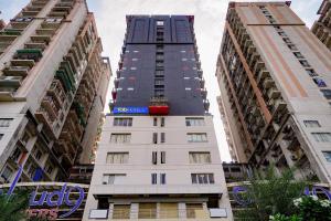 a tall building in the middle of two other buildings at FabHotel Prime Cloud 9 in Ghaziabad