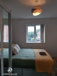 a bedroom with a bed and a window at Olive and Carols Walsall Stays in Walsall