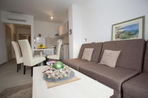 a living room with a couch and a table at Apartments Bota in Drvenik