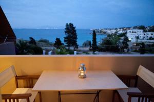 a vase sitting on a table in front of a window at Xanthippi Hotel in Souvala