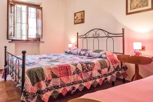 a bedroom with a bed with a quilt on it at La Casanuova in Lajatico