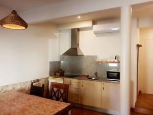 a kitchen with a table and a stove top oven at El Olivo in Torre del Compte