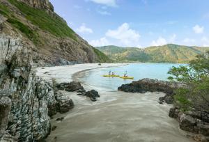 a group of people in boats on a river at Six Senses Con Dao - Turtle Island Paradise in Con Dao
