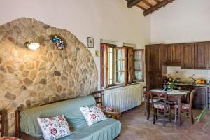 a living room with a couch and a stone wall at La Casanuova in Lajatico