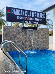 a sign for a swimming pool at a resort at Pandan Dua D'Penarik in Kampong Ru Sepuloh