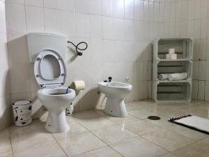 a bathroom with a toilet and a sink at Tarrafal Ecodécor Rooms in Tarrafal