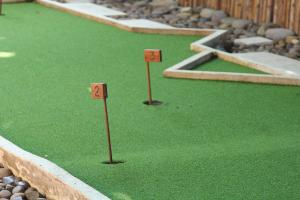 a miniature golf course with two sticks in the grass at Six Senses Con Dao - Turtle Island Paradise in Con Dao