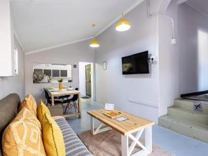 een woonkamer met een bank en een tafel bij Self-Catering at Cozy Comfort in Durban