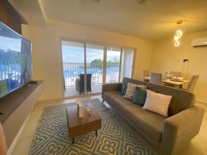 a living room with a couch and a flat screen tv at Vista al mar 303 in ArraijÃ¡n